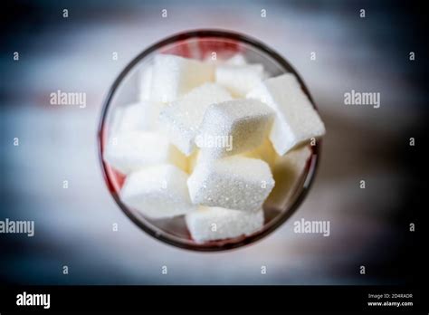 White Sugar Cubes In A Measuring Cup Conceptual Image On Sugar
