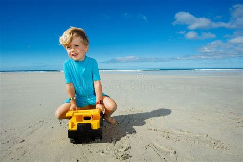 Boy Play With And Sit On Truck Toy At The Sand Sea Beach Stock Image