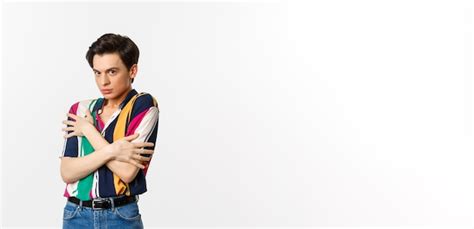 Imagem de um homem gay tímido se encolhendo e parecendo descontente a câmera se abraçando na
