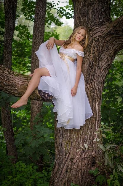 Premium Photo Innocent Blonde Girl In A White Dress Surrounded By Wild Nature