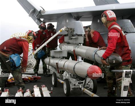 US Navy Weapons Handlers Assigned To The Valions Of Strike Fighter