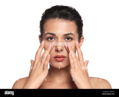 Woman applying cream under eyes on white background. Skin care Stock ...