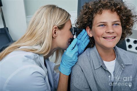 Ear Examination By Peakstock Science Photo Library