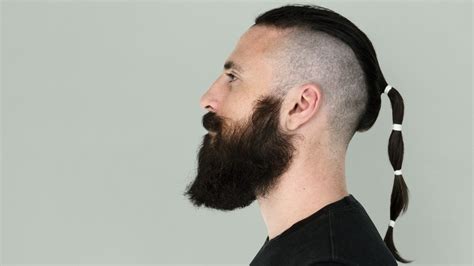 Rat tail hairstyle, a cropped or shaved head with a small long grown ...