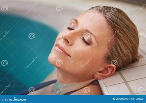 This Holiday Is Heavenly A Mature Woman Relaxing In An Indoor Swimming Pool Stock Image