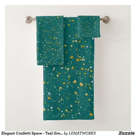 A Green Towel Hanging On The Wall With Gold Speckles And Dots All Over It