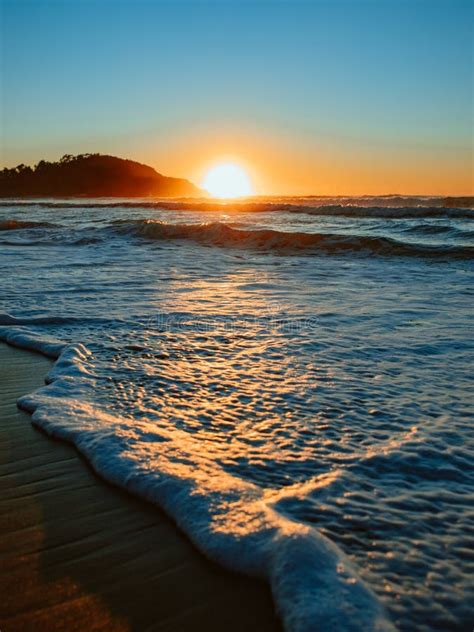 Colorful Ocean Beach Sunrise With Deep Blue Sky And Sun Rays Stock