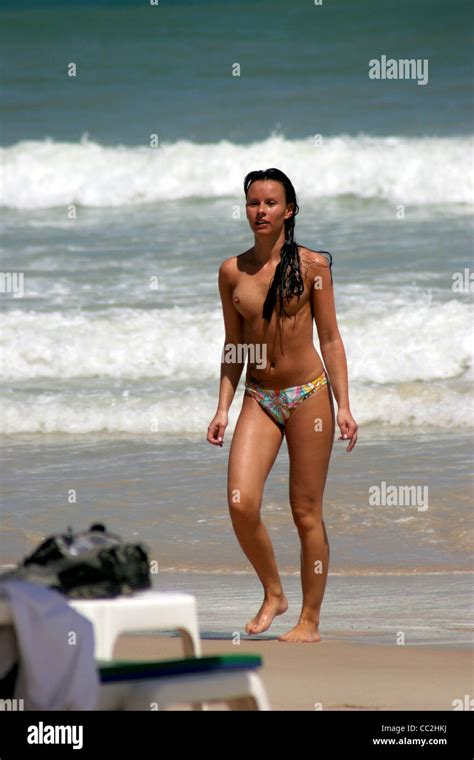 A Topless Woman Tourist Wearing Bikini Bottoms Is Enjoying Sandy Patong Beach In Phuket Island