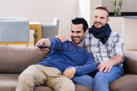 Gay Couple Watching Television With Pop Corn Stock Photo Image Of Holding House 66087776