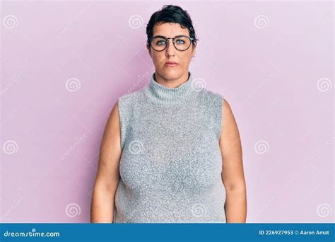 Plus Size Brunette Woman Wearing Casual Clothes And Glasses With Serious Expression On Face