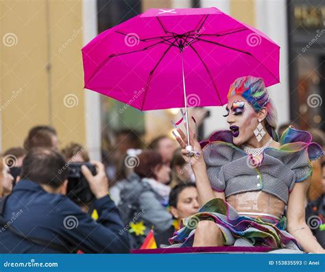 An Extravagant Drag Queen With A Pink Umbrella Attending The Gay Pride Parade Also Known As
