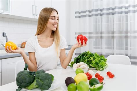 Premium Photo Cute Blonde Girl Choosing Which Bell Pepper To Eat