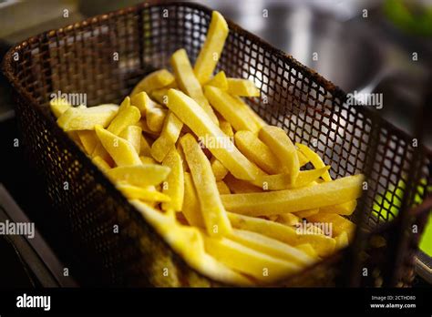 Raw Uncooked French Fries In Deep Fryer Oven In Fast Food Restaurant Kitchen Delicious Frozen