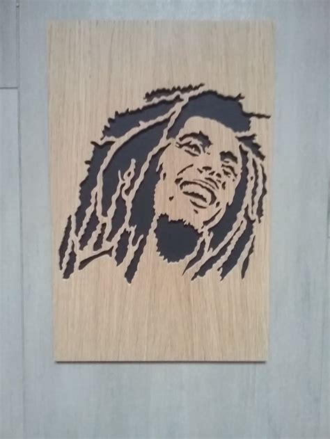 A Wooden Cutout Of A Man With Dreadlocks