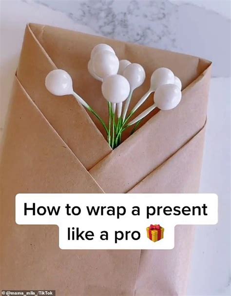 A Paper Bag With Flowers In It And The Words How To Wrap A Present Like