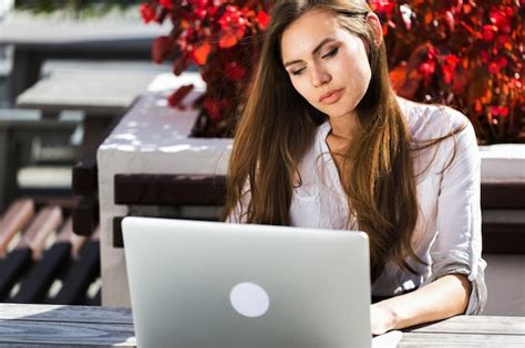 Free Photo Beautiful Brunette Works With Laptop Outside