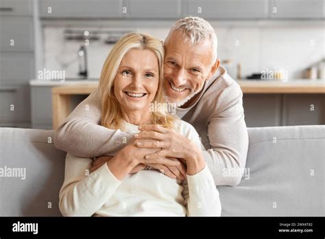 Mature Couple Smiling And Hugging Tightly Stock Photo Alamy