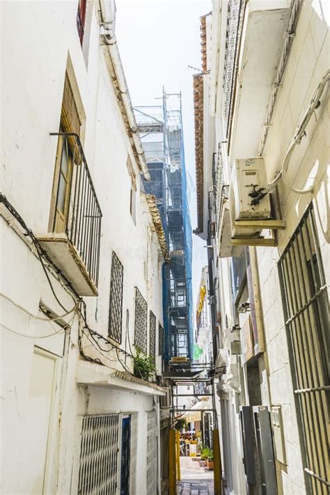 Traditional Andalusian Streets With Flowers And White Houses In