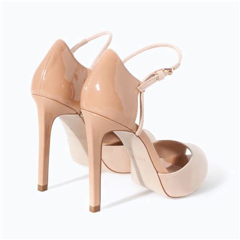 A Pair Of Nude Colored High Heeled Shoes