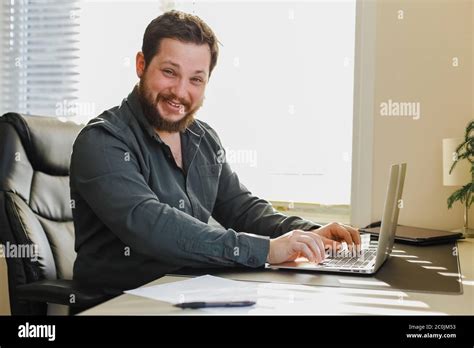 web developer sitting  office desk working  laptop computer stock