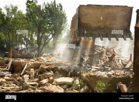 Demolition Of Residential Home With Bulldozer Preparing For New