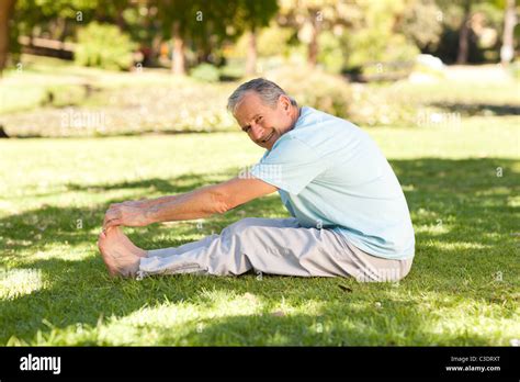 Mature Man Doing His Streches In The Park Stock Photo Alamy