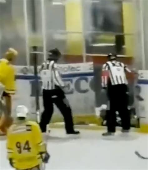 Hockey players fall into rink-side icy ditch after collision | New York ...