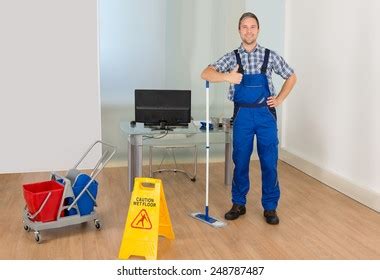 Male Janitor Cleaning Floor Caution Wet Foto Stok Shutterstock