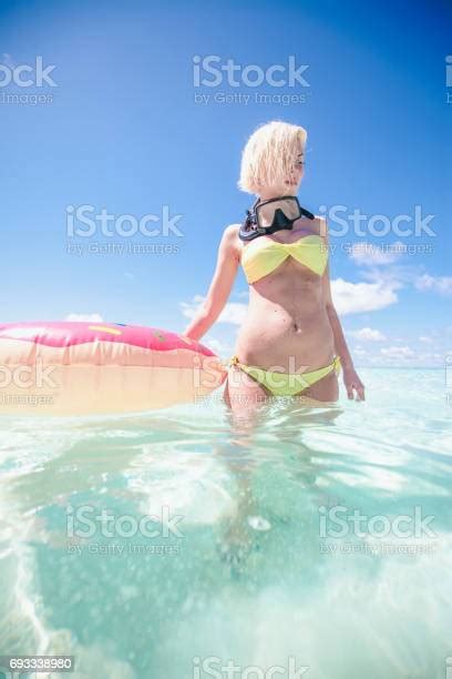 Blonde Woman Standing In Shallow Water With Snorkel Equipment Maldives