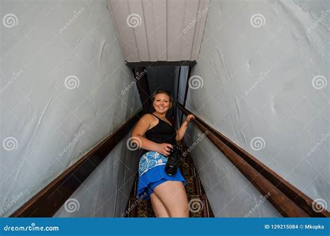 Blonde Woman Walks Up The Stairs On A Creepy Staircase In A Ghost Town In Wyoming Stock Photo
