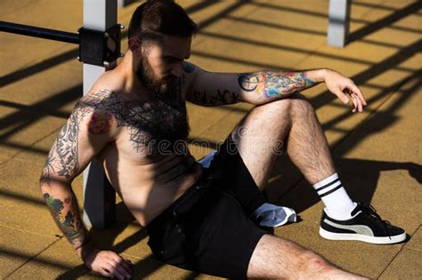 Muscular Bodybuilder Handsome Man With Naked Torso Trains Triceps In A Crossover Cable Exercise