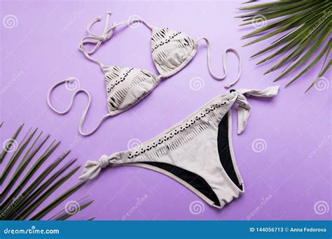 Summer Background With Palm Leaves And Bikini On Violet Or Purple