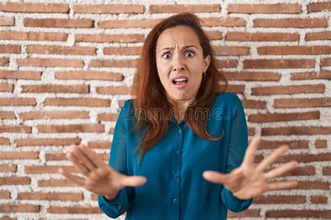 Brunette Woman Standing Over Bricks Wall Afraid And Terrified With Fear Expression Stop Gesture