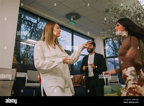Beautiful Brunette Businesswoman Dancing With Her Blonde Female Coworker After Successfully