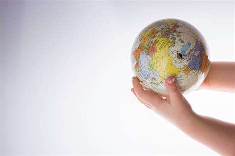 Premium Photo Cropped Hands Holding Globe Over White Background