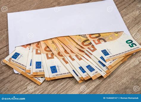 White Envelope With Euro Bills Over Wooden Background Stock Image