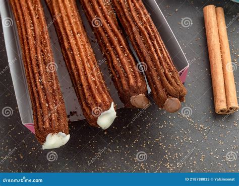 Top View Of Take Away Coffee Next To Chocolate Filled And Plain Churros