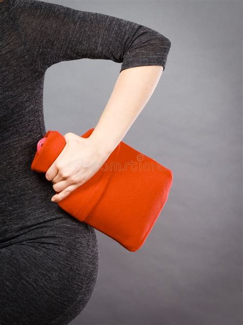 Woman Holds Hot Water Bottle In Red Fleece Cover Stock Photo Image Of Remedy Water