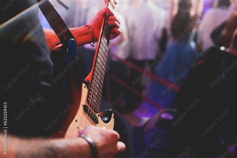 Concert View Of An Electric Guitar Player With Vocalist And Rock Band