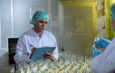 Product quality control officer in fruit juice production line Carry out an inspection of ...