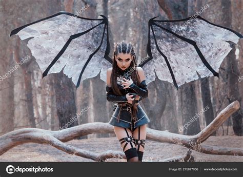 Female Demon With And Dark Makeup Girl With Big Wings In Black Short Leather Latex Skirt And