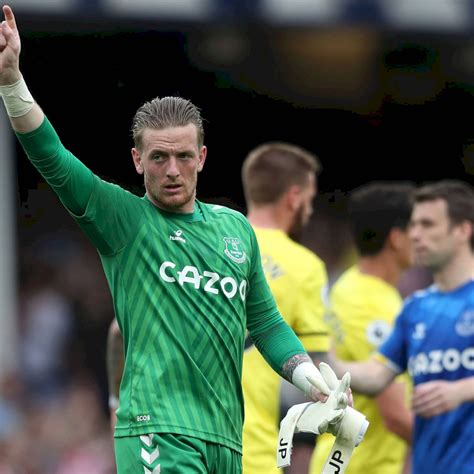 Download Jordan Pickford Holding His Gloves Wallpaper