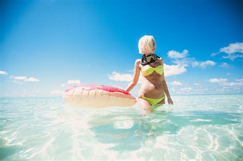 Blonde Woman Standing In Shallow Water With Snorkel Equipment Maldives