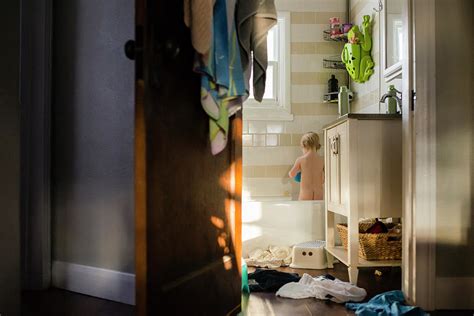 Rear View Of Naked Boy Standing In Bathtub Seen Through Doorway At Home Photograph By Cavan