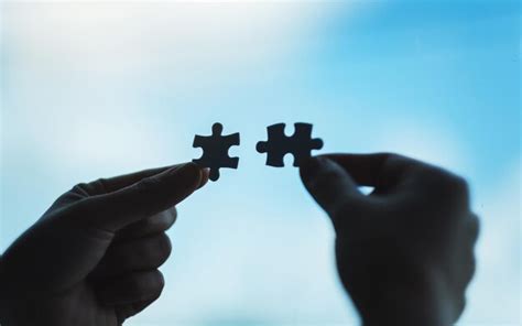 Premium Photo Hands Holding And Putting A Piece Of White Jigsaw