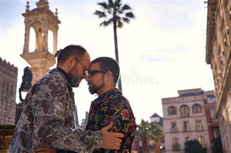 Real Marriage Of Gay Couple Walking Down The Street Hands Full Of Shopping Bags Happy And