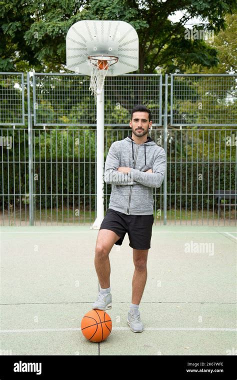 Portrait Of An Amateur Basketball Player With His Foot On A Ball On An