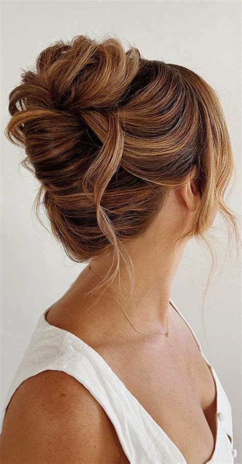 Chic Updos To Elevate Your Hair Game Messy Chignon With Strands Of