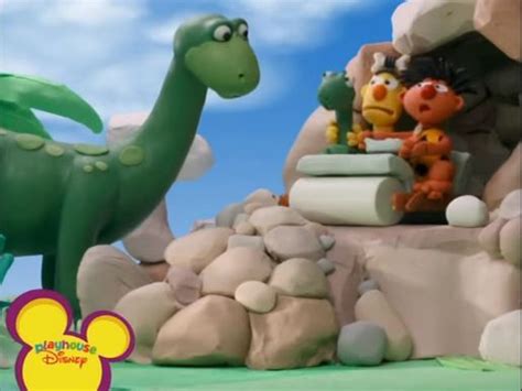 an animated scene with dinosaurs in the background