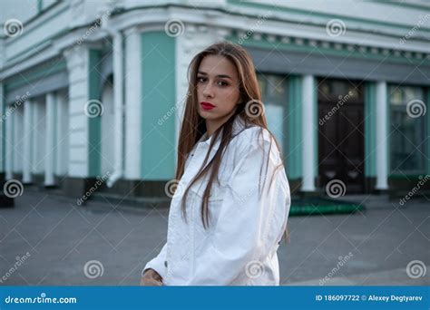 Attractive Brunette Portrait The Girl Touches Her Hair With Her Hand Stock Photo Image Of